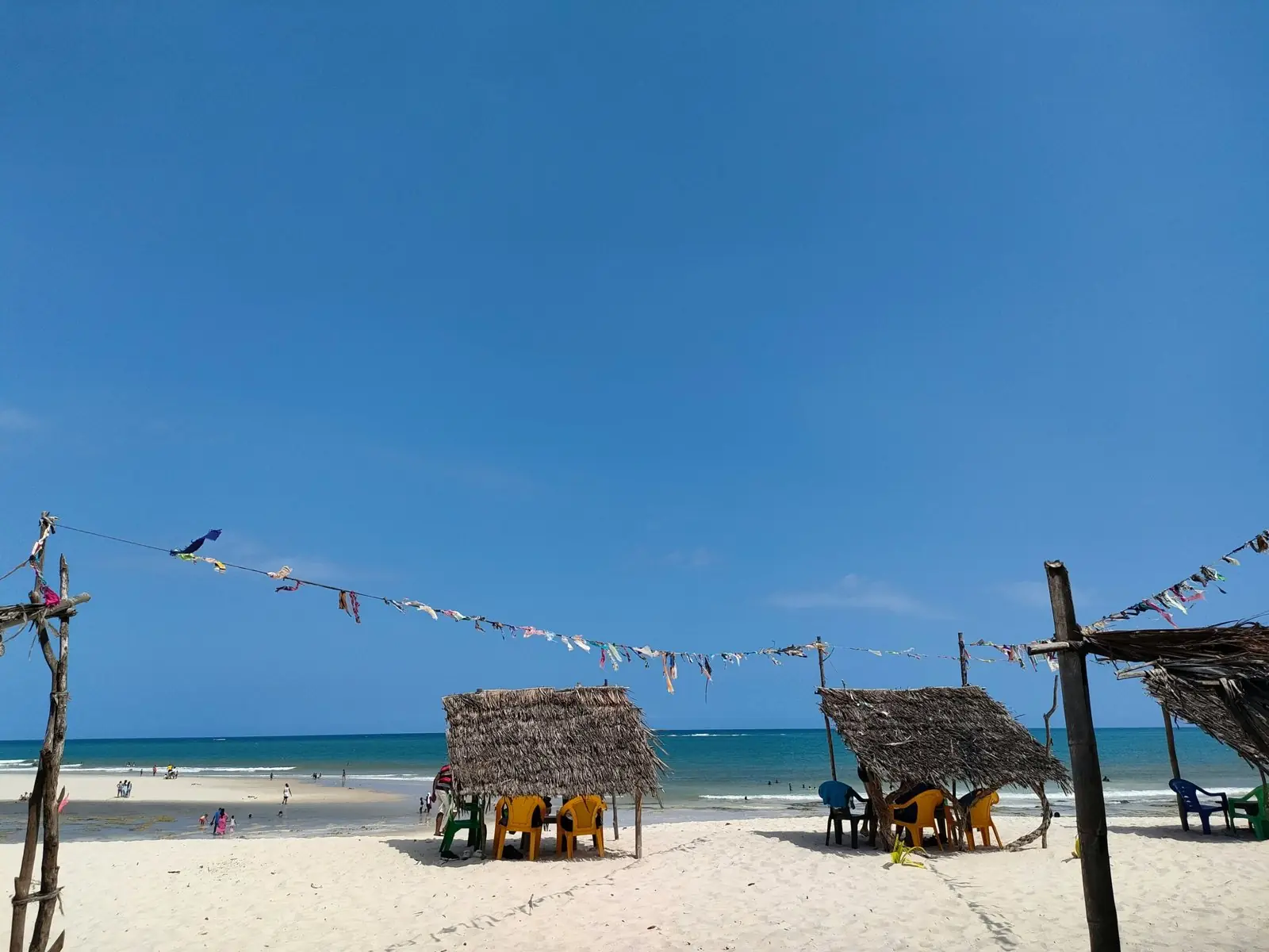 White-sand beach with thatched shades on Kenya's south coast