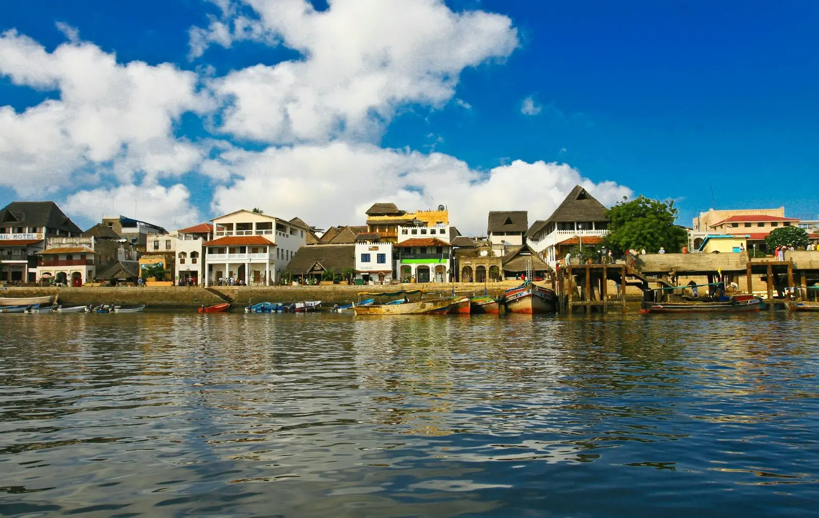 Lamu old town waterfront with dhows and boats moored